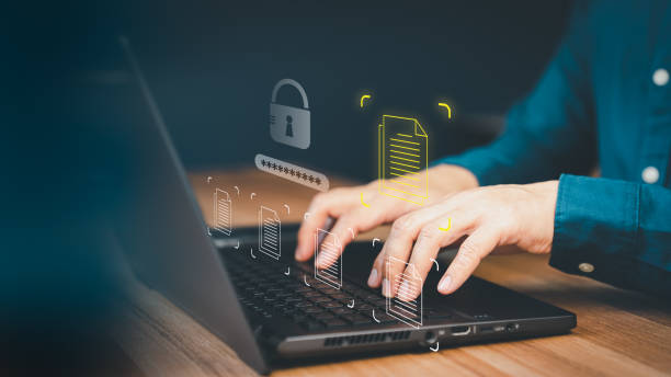 istock Document management concept with icons on ERP virtual screen. Employee typing on a computer keyboard checking documents in office. Online documentation database to efficiently manage files. 1502102981