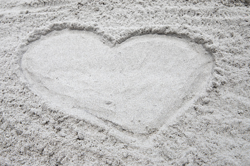 heart shaped sandy beach outline calm soothing sand beach background with copy space