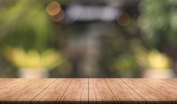 istock Empty wooden table top with lights bokeh on blur restaurant background. 1502111766
