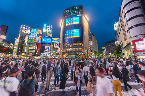 Tokyo, Japan - May 28, 2023 : Crowds crossing Shibuya scramble crossing, the famous intersection in Tokyo outside Shibuya station at night