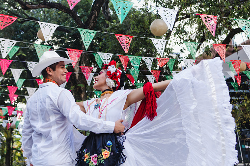 Portrait of a mid adult woman dancing in traditional festival at public park