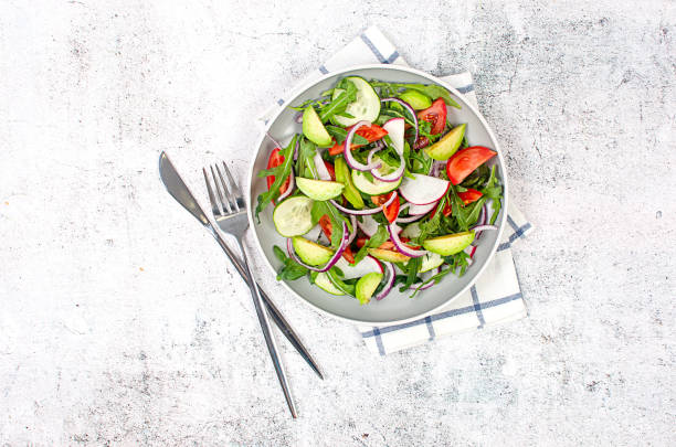 istock green salad with arugula, tomatoes, cucumber and avocado. 1502126225