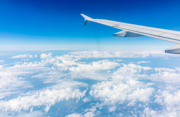 istock View from the airplane window at a beautiful cloudy sky and the airplane wing 1502127674
