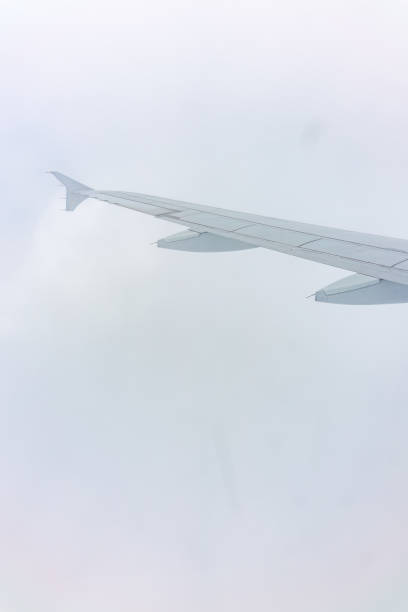 istock View from the airplane window at a beautiful cloudy sky and the airplane wing 1502127707