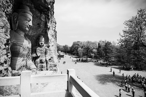 Otagi Nenbutsu-ji, Arashiyama, Kyoto, Japan - November 21st, 2018: Old moss covered Buddhist Rakan Stone Statues - Rakan Sculptures close Arashiyama - Otagi Nenbutsu-ji Area side by side in row. Otagi Nenbutsu-ji, Arashiyama, Kyoto, Japan, East Asia, Asia.