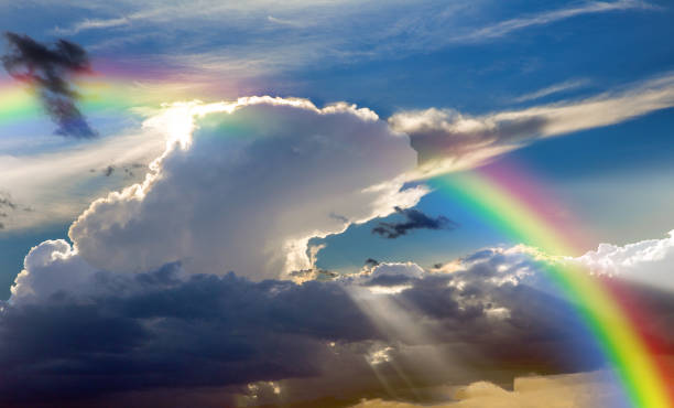 istock Rays of the sun breaking through the stormy sky, forming a marvelous rainbow 1502131319