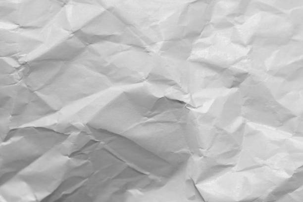 istock White crumpled and creased paper poster background. 1502131947