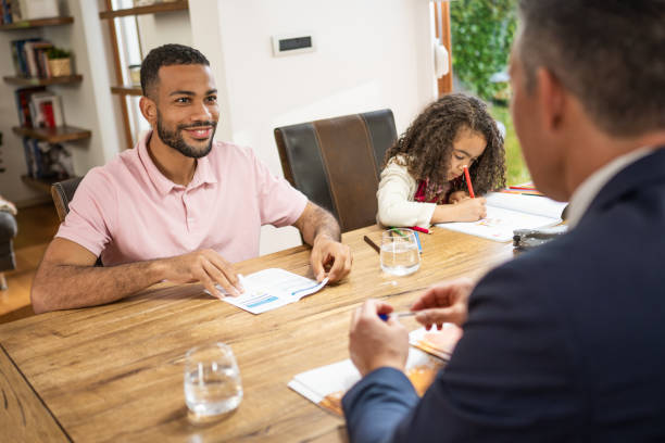 istock Man discussing mortgage agreement with real estate agent 1502135393