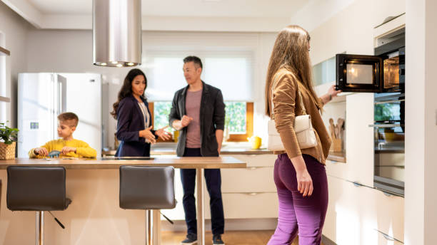 istock Woman checking microwave at real estate showing 1502135542