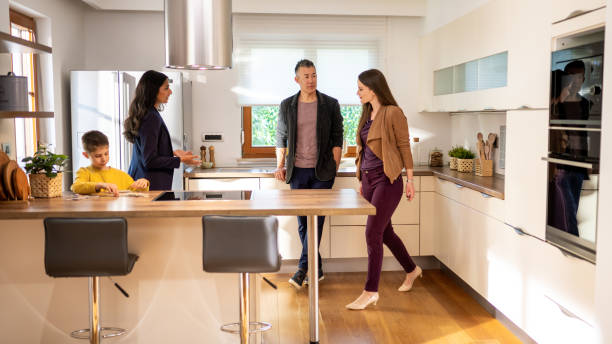 istock Real estate agent showing modern kitchen to couple 1502135675