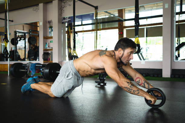 istock Fit man using the ab wheel in a gym 1502136907