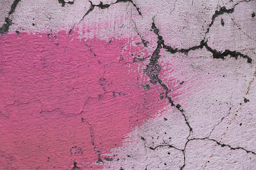 Pink stroke on  creked wall