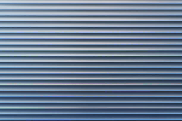 Texture and pattern of exterior roller aluminum shutters on a large shopwindow as background