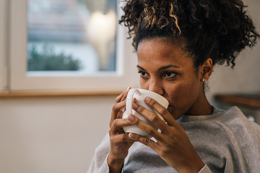 Close up view of a woman drinking coffee