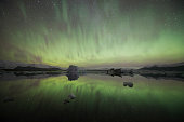 The deep green - icebergs floating at Jökulsárlón Lagoon with wonderful spectacular aurora in the sky  -  Iceland