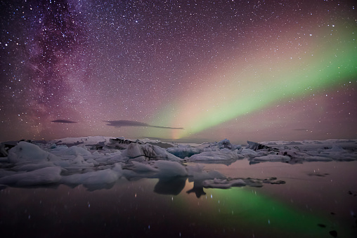 icebergs floating at Jökulsárlón Lagoon with wonderful spectacular aurora in the sky - Iceland