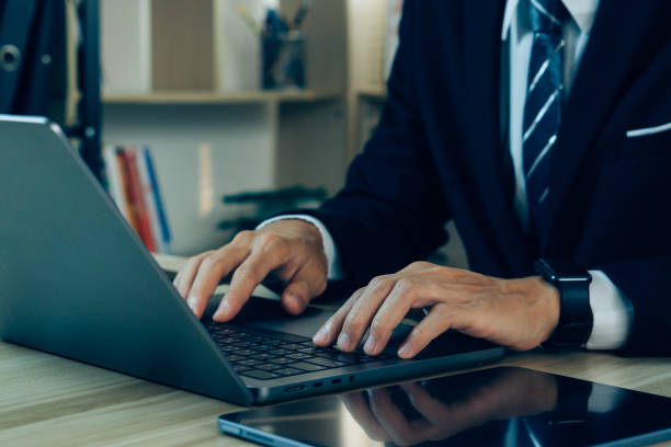 istock Close-up hand of businessman sitting in office working with laptop computer.copy space. 1502148794