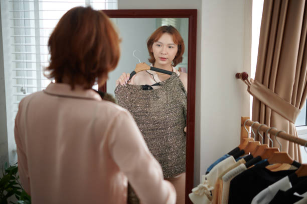 istock Woman Trying on Sweater 1502152763