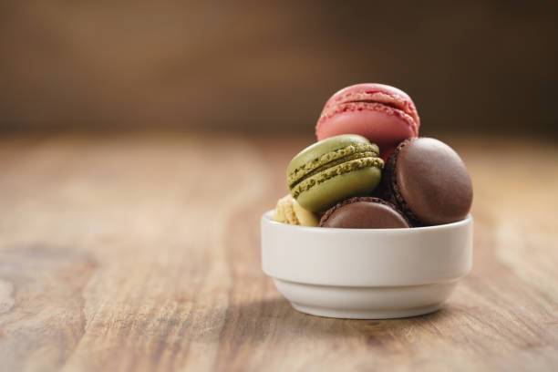 istock assorted macarons in white bowl on wooden table 1502167317