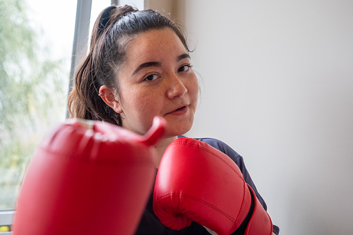 A girl exercising with boxing gloves on