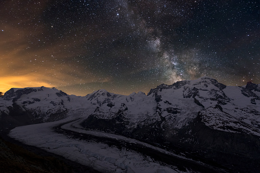 Monte Rosa mountain range and the Gorner Glacier at Night with milky way in the sky - Switzerland