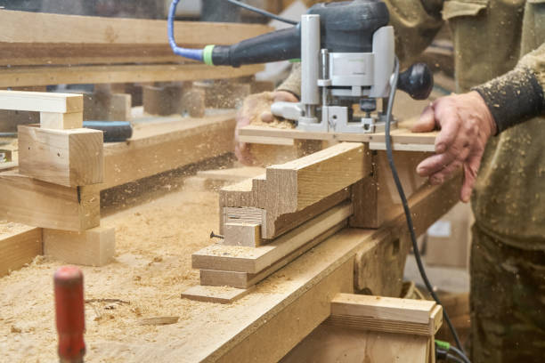 istock Carpenter milling wooden handrail with manual milling machine 1502179523