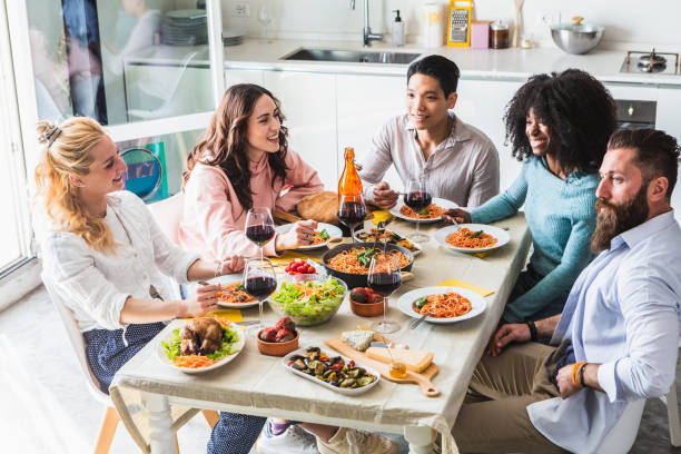 istock Group of multiethnic friends sitting at the table during lunch 1502188603
