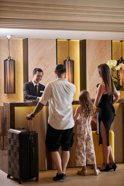 istock Family Standing at Hotel Reception 1502190496