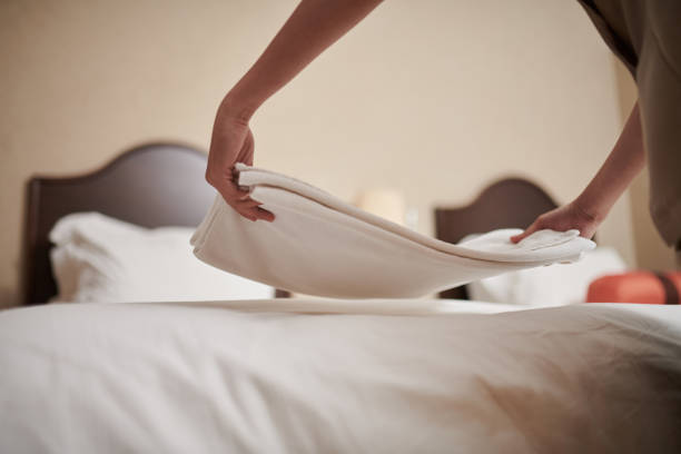 istock Maid Putting Linen on Bed 1502191058