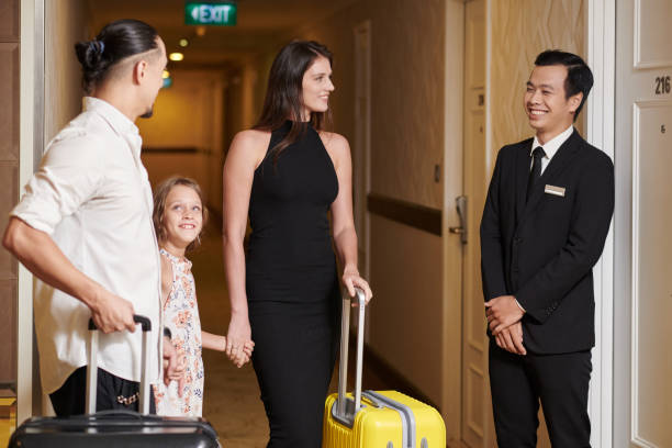 istock Receptionist Showing Family Their Room 1502191084