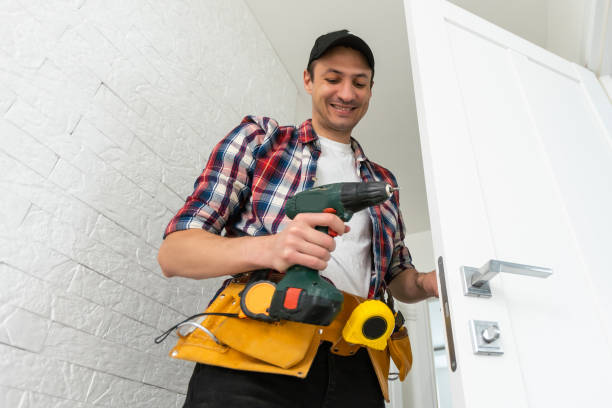 istock Man remove the door. Twists self-tapping screw with a screwdriver. Stainless door hinges on a white door. 1502200308