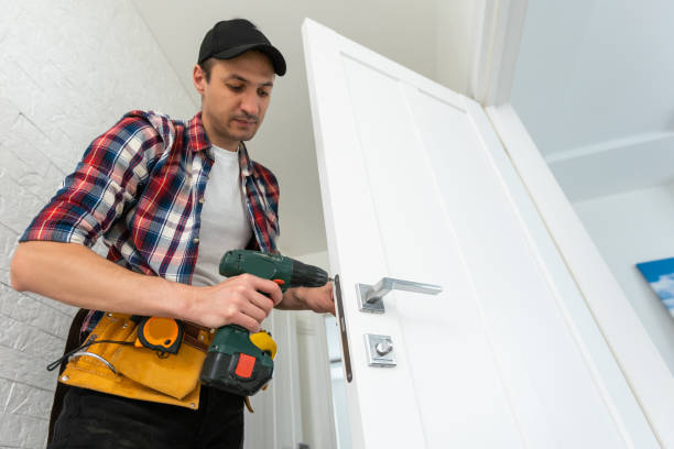 istock Carpenter repairing door lock. Installing a door handle 1502200362