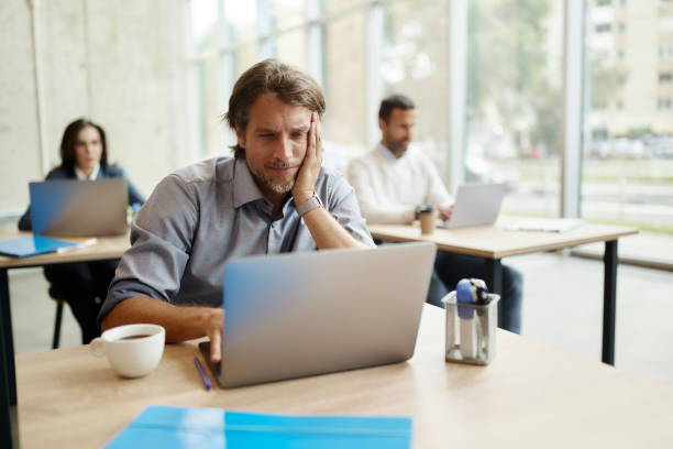 istock Male entrepreneur working on laptop at corporate office. 1502207461