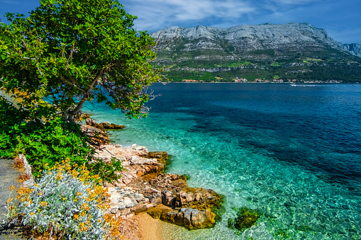 The beautiful turquoise waters of the Adriatic Sea and coastline, Korcula, Croatia, Europe.