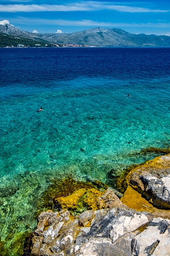 The beautiful turquoise waters of the Adriatic Sea and coastline, Korcula, Croatia, Europe.