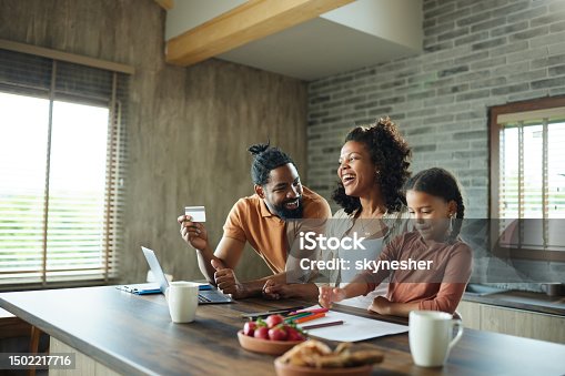 istock Happy black family shopping online at home. 1502217716