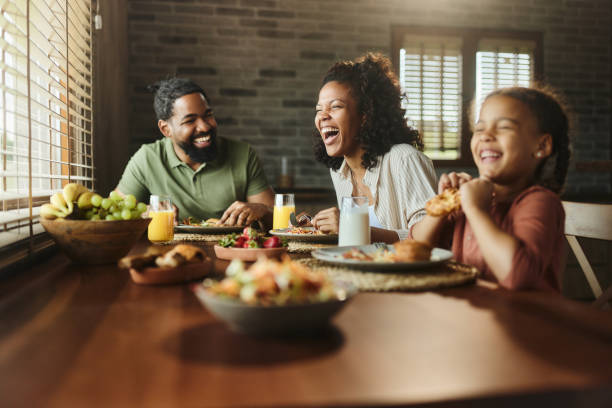 istock Cheerful black family having fun during a meal at dining table. 1502218850