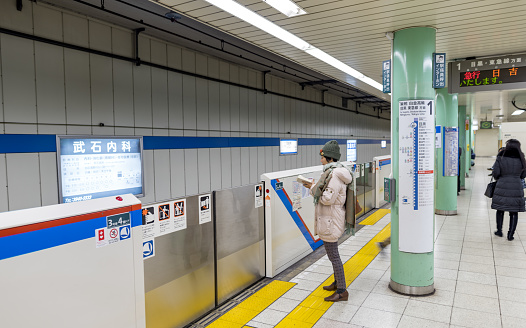 Tokyo, Japan - February 17, 2018: Tokyo metro and people are waiting for the train.