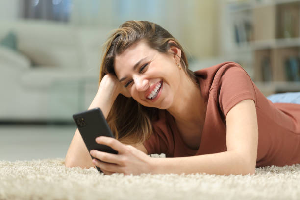 istock Happy woman watching phone videos 1502221249
