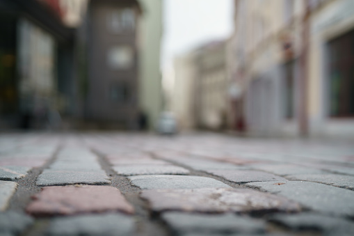 low angle closeup background of old pavement with blurred background, shallow focus