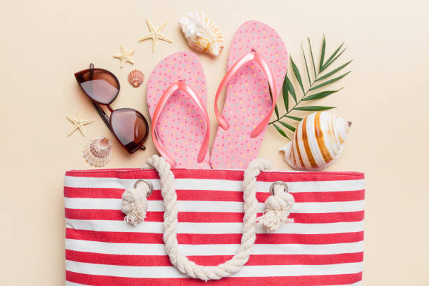 istock beach accessories flat lay top view on colored background Summer travel concept. Bag with starfish and sea shell. Top view 1502226048