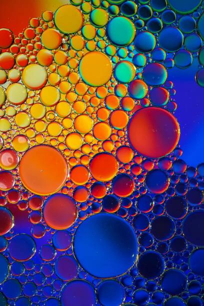 istock multi colored oil circles on the water, colorful background 1502226424