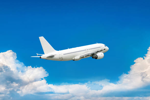 istock White passenger airliner in the air above scenic clouds 1502228436