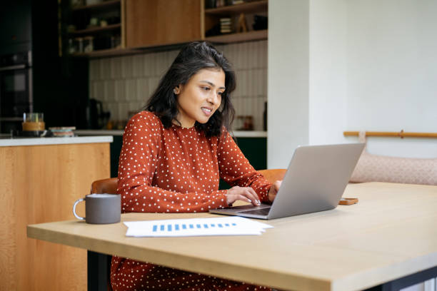 istock British Indian businesswoman using laptop at home 1502237005