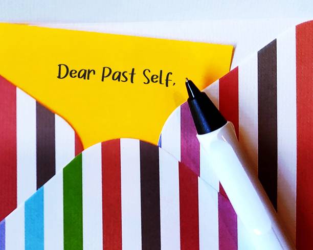 Letter with handwritten text DEAR PAST SELF, concept of self reflection - writing a letter to the person you were, advice to give your past self to tell them about what happened then and now