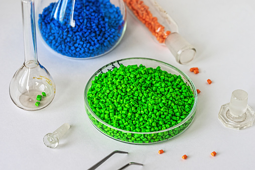 Plastic factory laboratory. Petri dish with colored dye in granules for plastics. polymer industry.