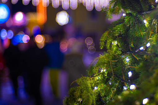 Close up of illuminated Christmas tree with abstract bokeh background at night