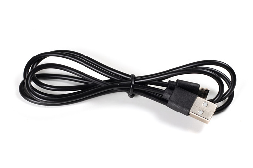 Close-up of a USB cable with standard A and micro-USB standard B connectors isolated on a white background. Black cable for data transfer between devices.