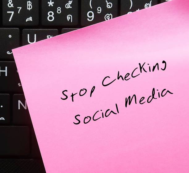 istock Pink note stick on keyboard with handwritten text STOP CHECKING SOCIAL MEDIA, decision making to stay away from social media to gain more time to something else, less distracted and less stressed 1502284506