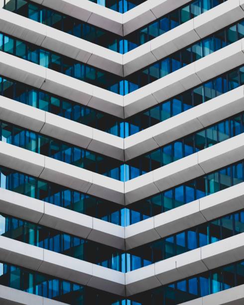 An exterior view of a modern office building, featuring glass windows